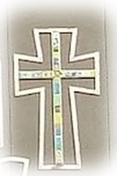 The cross symbol, set with small panes of colored glass, carved into Plymouth Church's facade